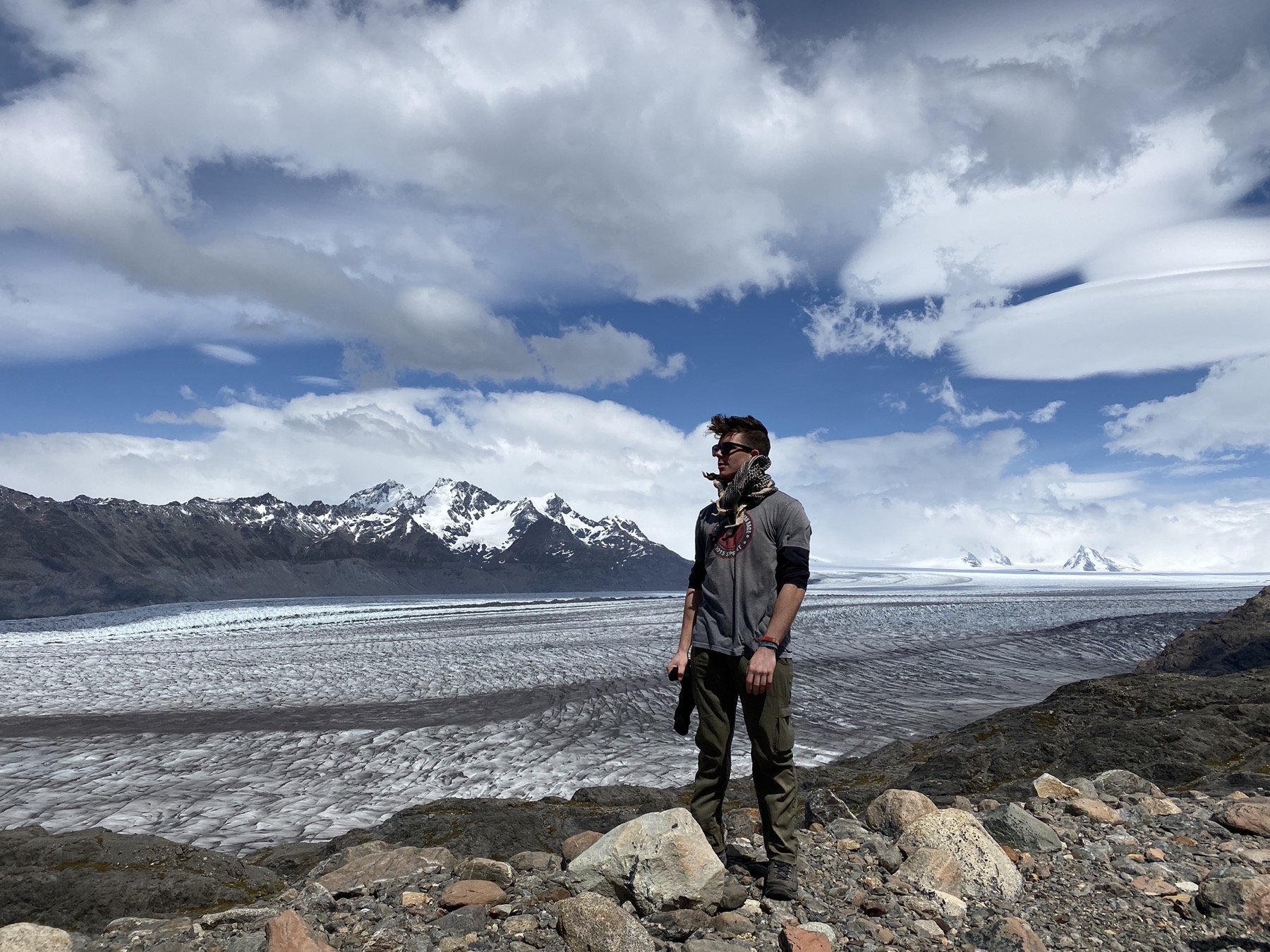 Brian Morris standing beside a glacier in the mountains